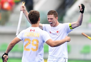 Canada's Scott Tupper celebrates scoring with his teammates during the mens's field hockey India vs Canada match of the Rio 2016 Olympics Games at the Olympic Hockey Centre in Rio de Janeiro on August, 12 2016. / AFP / MANAN VATSYAYANA (Photo credit should read MANAN VATSYAYANA/AFP/Getty Images)