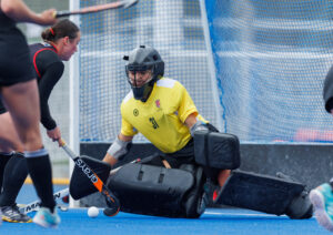 Rowan Harris, in goal for Canada, slides across the goal mouth.